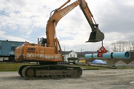 Kenco Pipe Lift Attached to the Lift Eye of Excavator Bucket