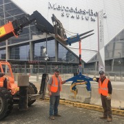 two stadium workers with Kenco lift by Mercedes Stadium