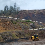 rock quarry road edged with barrier wall