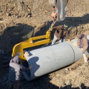 excavating team in ditch installing pipe