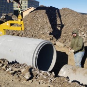 rcp pipe being set down in ditch