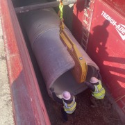 pipe hook with large concrete pipe in red trench box