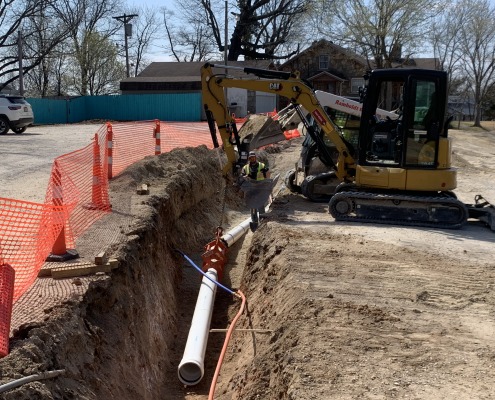 white water pipe being installed in trench