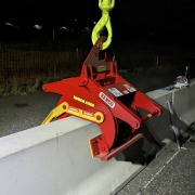 red clamp sitting on jersey barrier wall at night