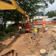 excavator reach over construction site
