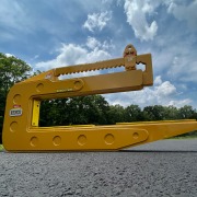 cat yellow c shaped pipe lifting device casts shadow