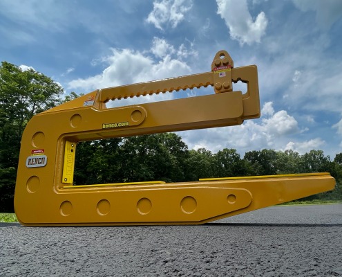 cat yellow c shaped pipe lifting device casts shadow