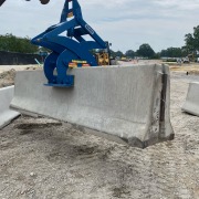 barrier clamp device gripping heavy concrete jersey wall
