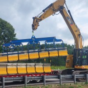 Zipper wall lifter picking up seven walls at one time to load onto a trailer
