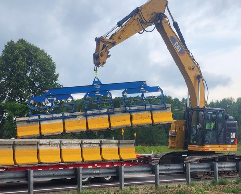 Zipper wall lifter picking up seven walls at one time to load onto a trailer