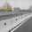 A selective focus shot of a long row of concrete barriers lining the side of an empty major highway.