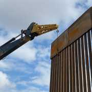 border wall panels being installed in Texas at the Mexico border with a jib boom attachment