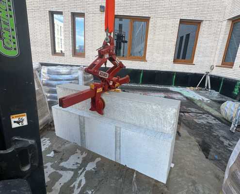 tool for safely moving large concrete odd shaped block with a rigging strap