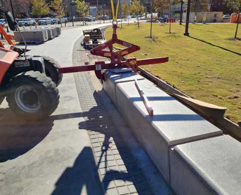 final setting of precast concrete benches in a row