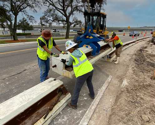 road construction team installing florida low profile curb walls