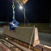 roadway construction at night setting barrier wall