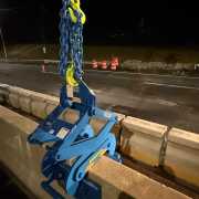 closeup of blue barrier lift on concrete barrier wall at night