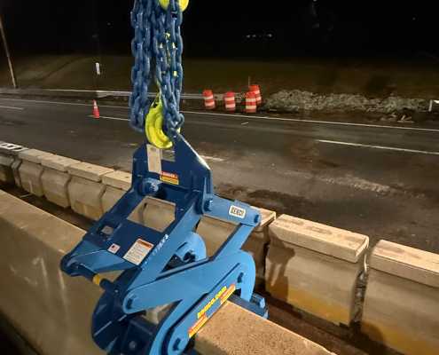 closeup of blue barrier lift on concrete barrier wall at night