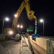 excavator at dark moving concrete wall