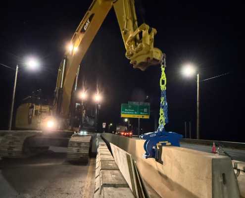 excavator at dark moving concrete wall