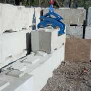 large waste block in front of stacked block picked up with kenco barrier lifter