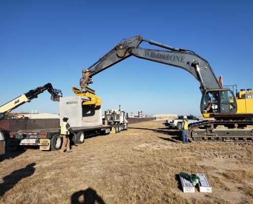 long reach excavator unloading box culvert from truck