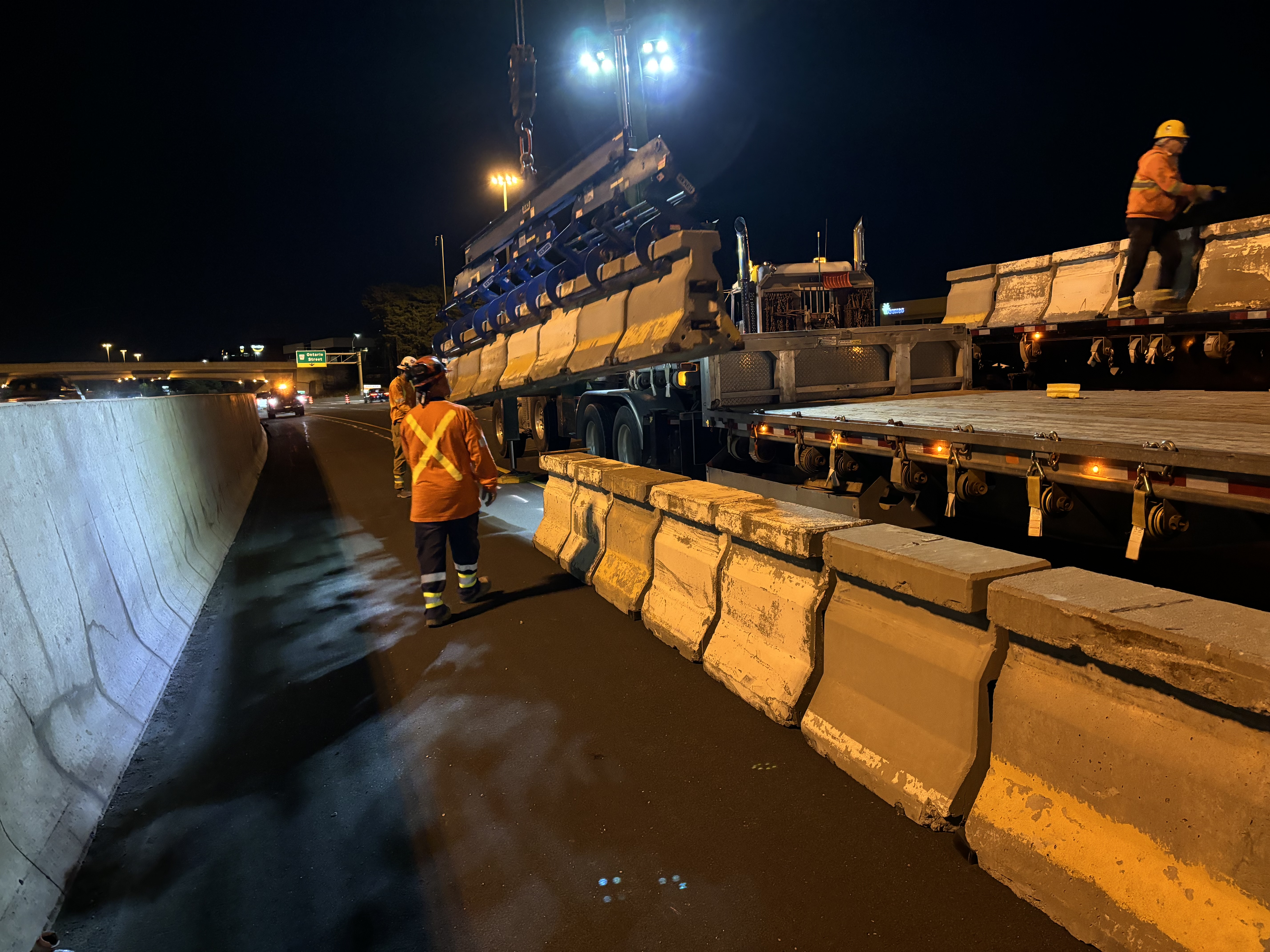 installation of multiple zipper wall barriers at nighttime
