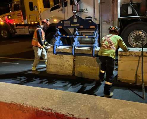 nightime road construction site setting multiple concrete zipper wall