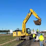 distant shot of active jersey barrier installation with work done by siema construction using a blue kenco barrier lift